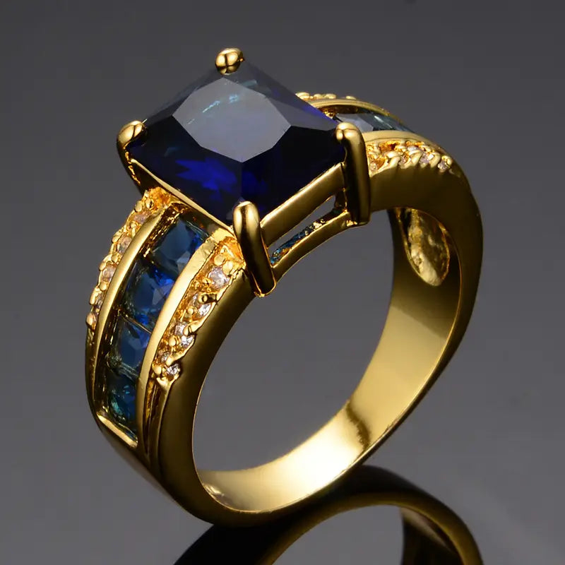 Cushion-Cut Blue Stone Cocktail Ring with Gold-Tone Band and Side Accent Stones — main image