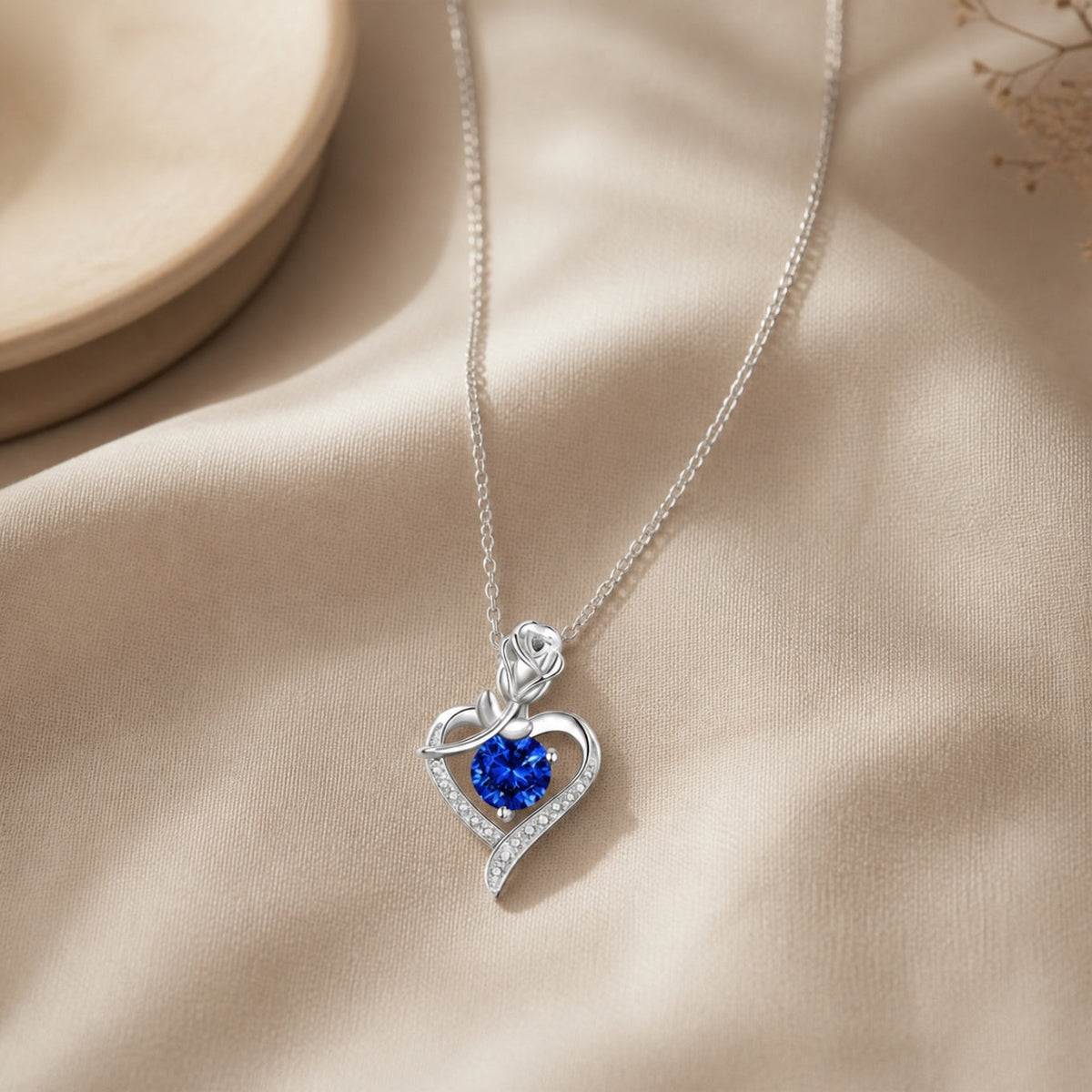 Heart-Shaped Sapphire Blue Pendant Necklace with Rose Detail and Silver-Tone Chain — main image