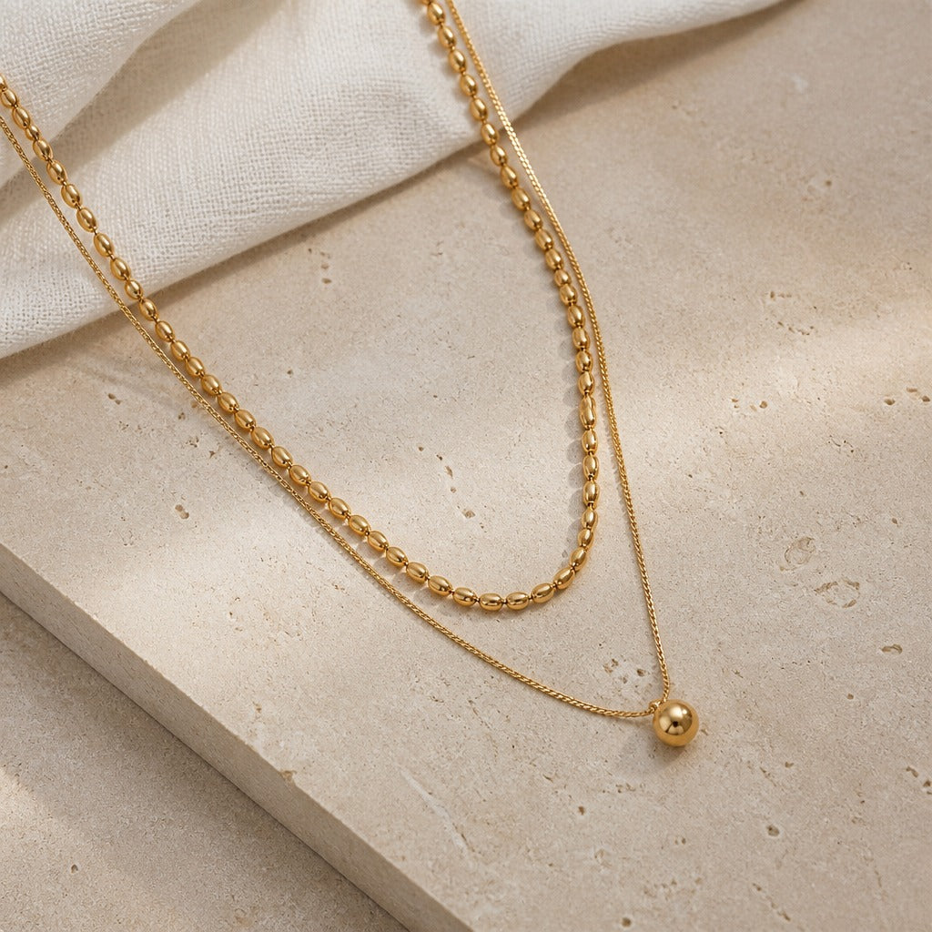 Layered Gold Necklace with Beaded Chain and Spherical Pendant — view 2