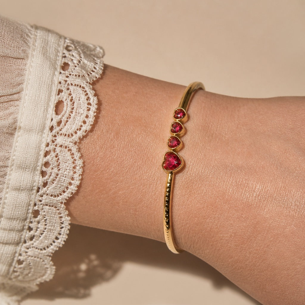 Heart Charm Bangle with Bezel-Set Red Stones in Gold-Tone Finish — main image