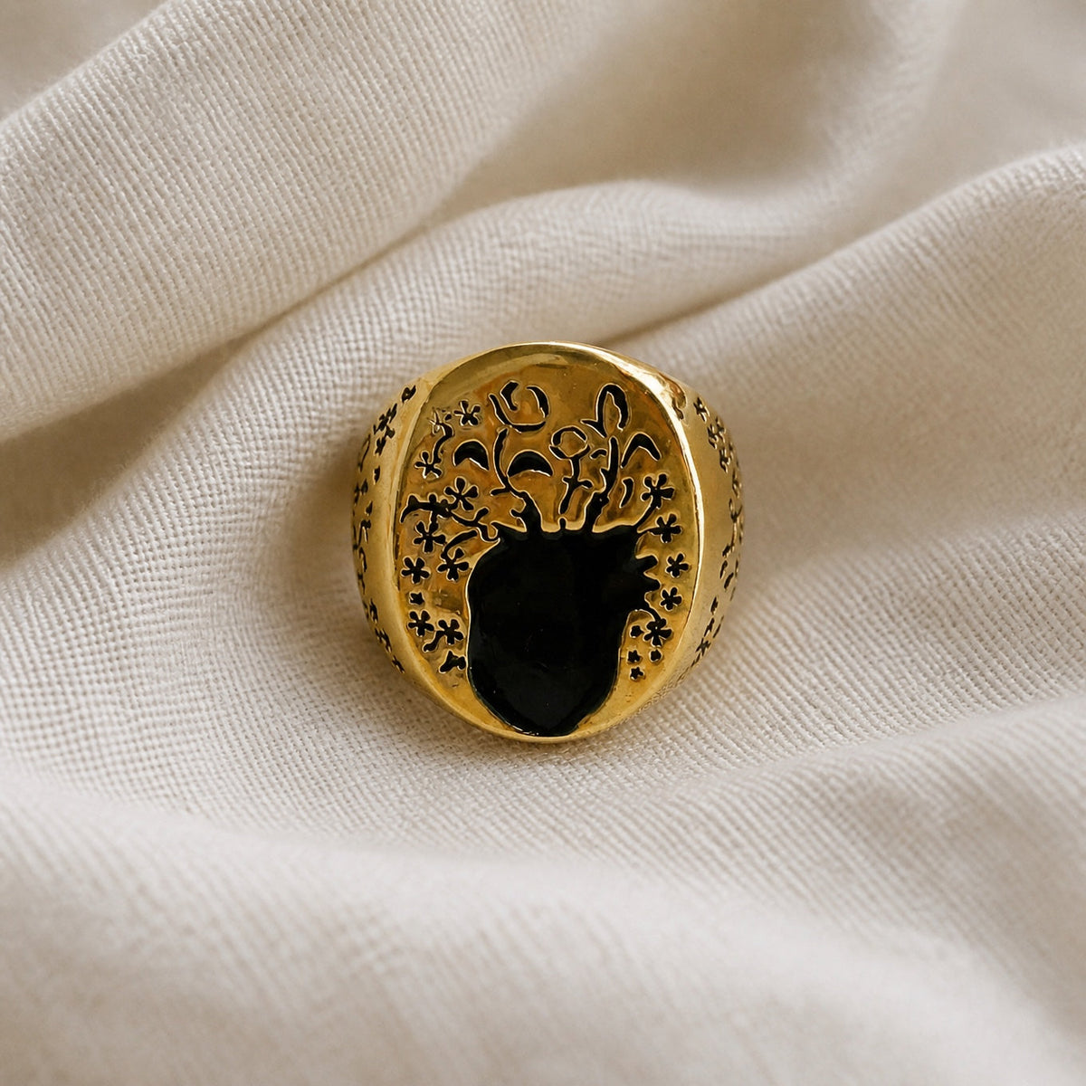 Oval Black Stone Statement Ring with Floral Border, Gold Tone — main image