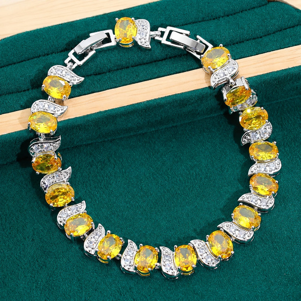 Oval-Cut Golden Yellow Cubic Zirconia Tennis Bracelet with Leaf Spacers — main image