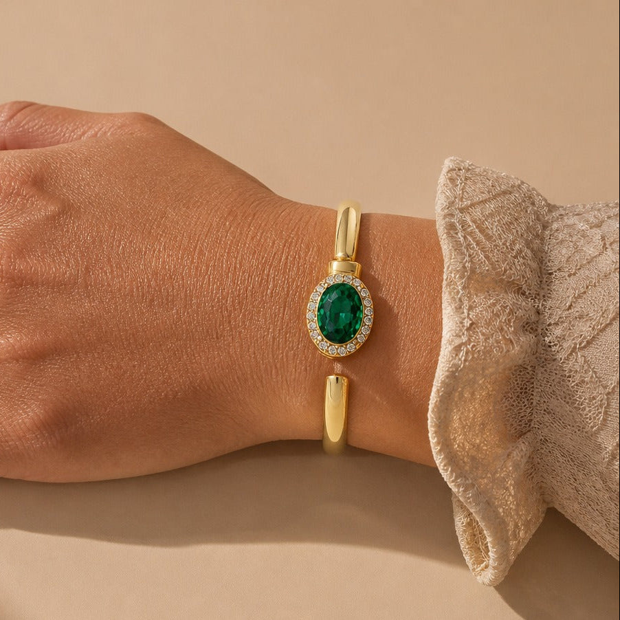Oval Emerald-Tone Halo Bangle Bracelet with Crystal Accents in Gold Tone — main image