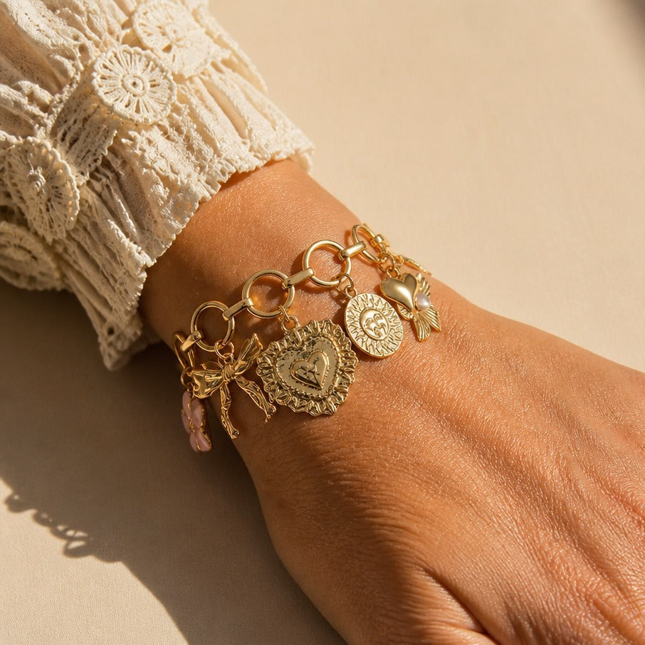 Bow and Medallion Charm Bracelet in Gold Tone with Pink Stone Accent — main image