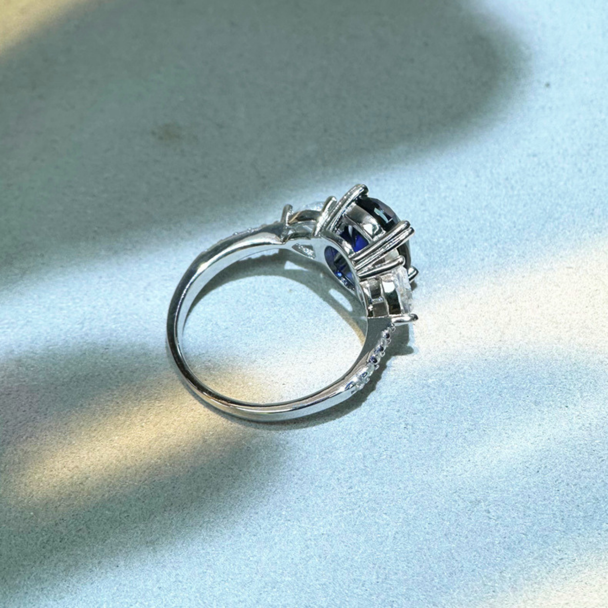 Oval Blue Sapphire Three-Stone Ring with Accent Stones — view 3