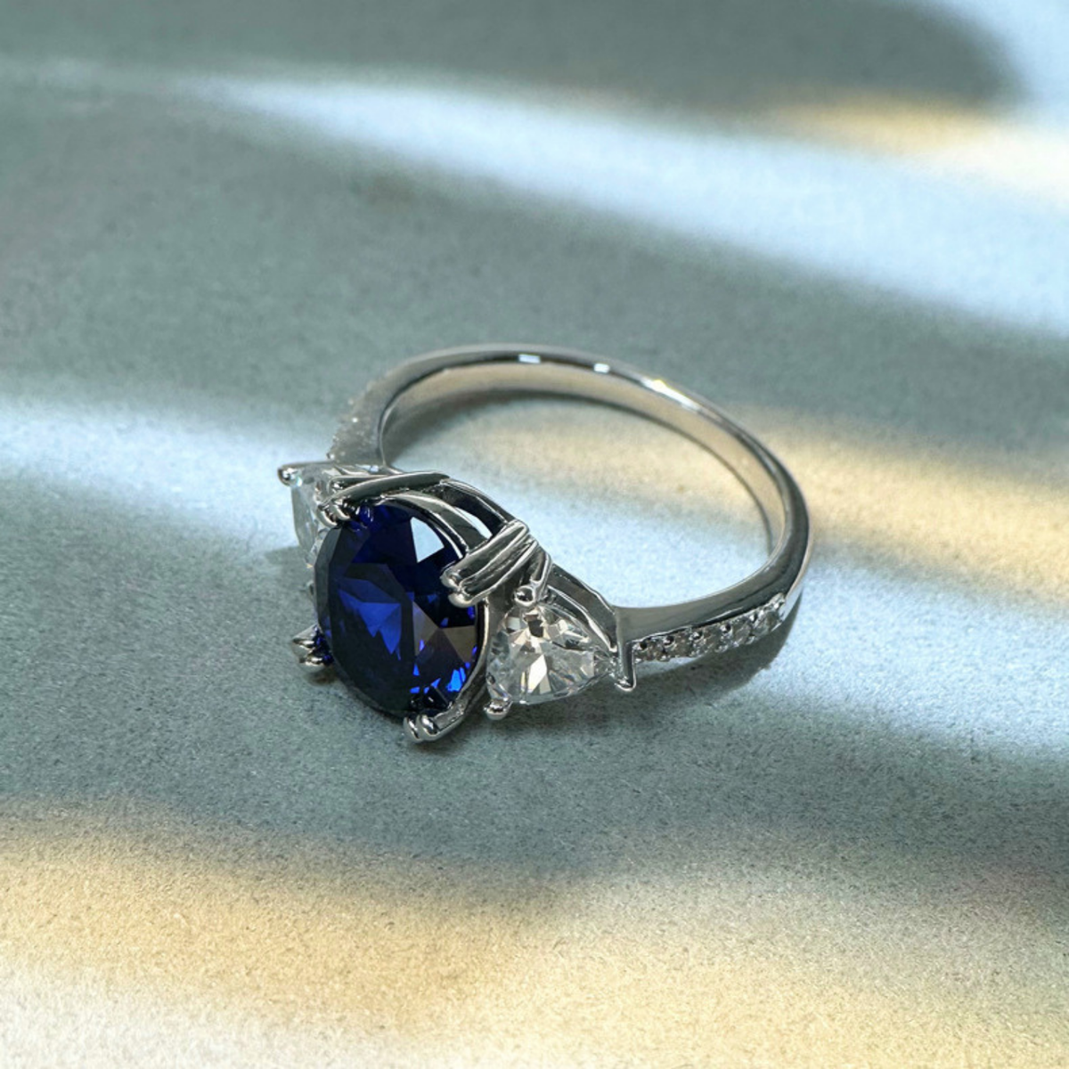 Oval Blue Sapphire Three-Stone Ring with Accent Stones — view 2