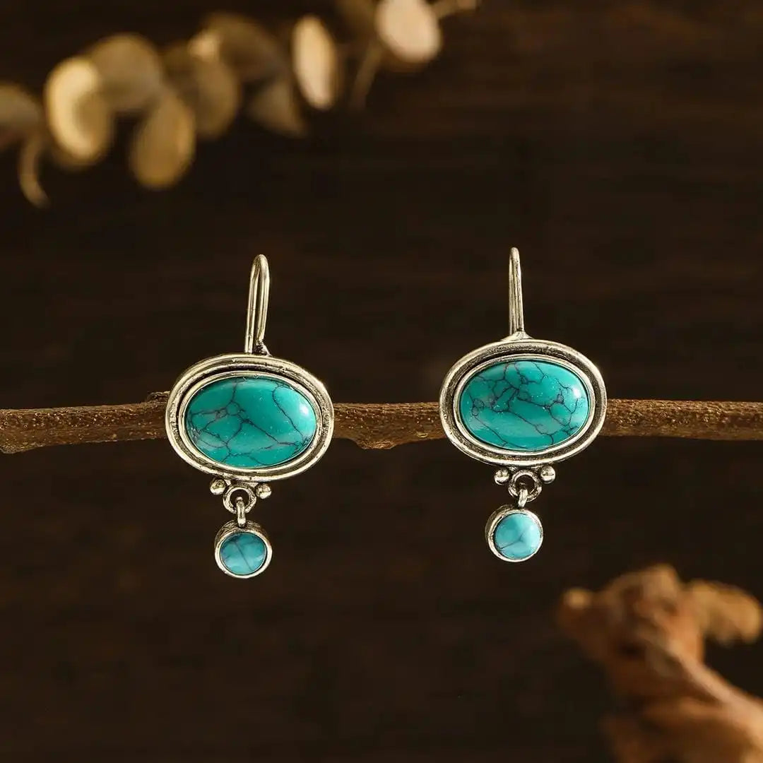 Oval Turquoise Drop Earrings with Silver Bloom Detail and Round Stone Accent — main image