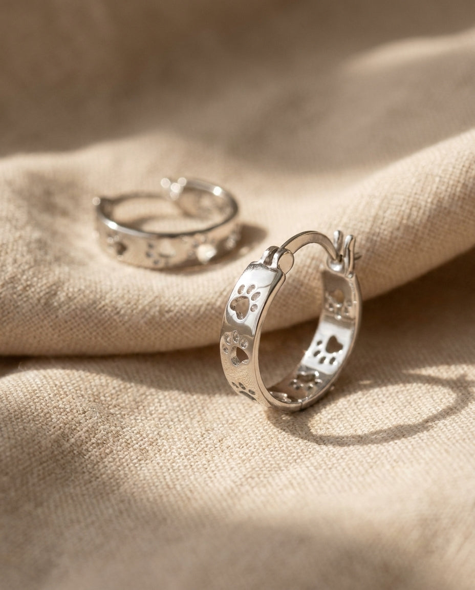 Estelle & Ruby Paw Print Hoop Earrings – Copper, White Gold Plated, Hinged, 20mm (AI-generated studio image)
