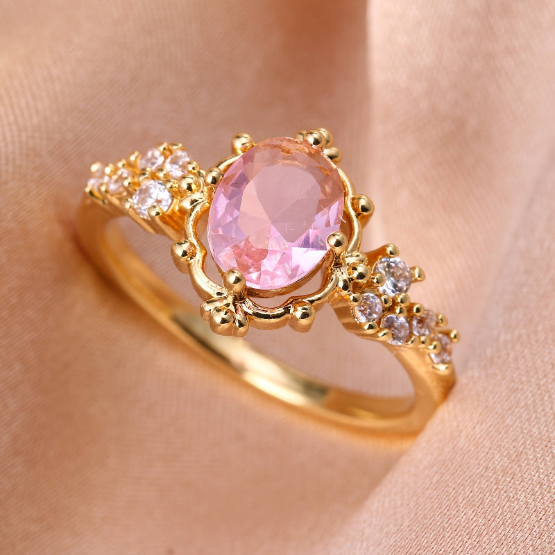 Oval Pink Halo Ring with Cubic Zirconia Accents and Gold-Tone Band — main image