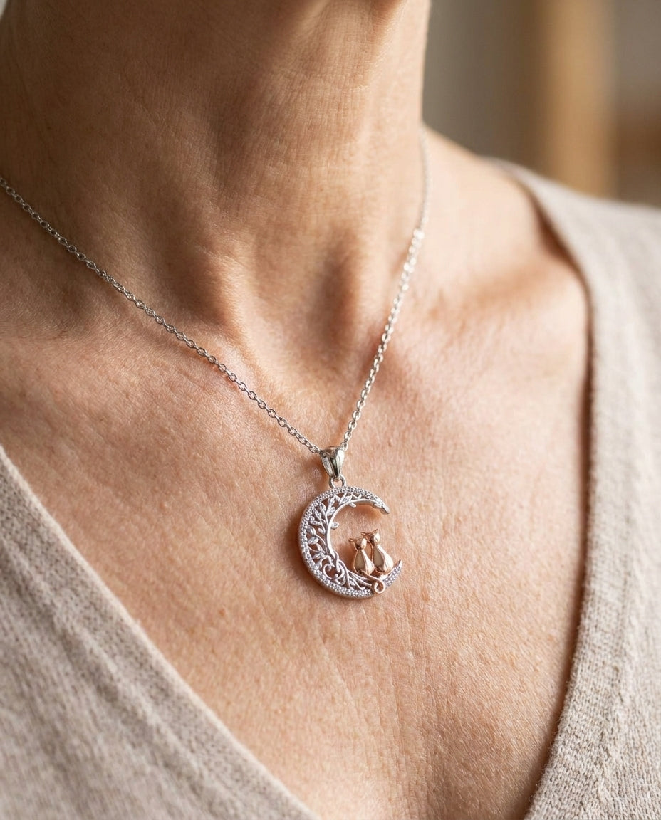 Estelle & Ruby Cat & Moon Pendant Necklace – Crescent Moon Filigree, Two Cats, CZ Stones, Silver & Rose Gold Tone (AI-generated lifestyle image)