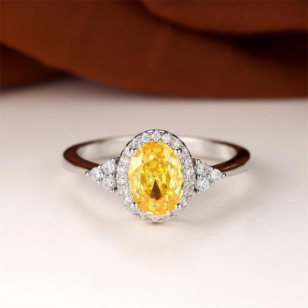 Oval Yellow Cubic Zirconia Halo Ring with White Accent Stones — main image