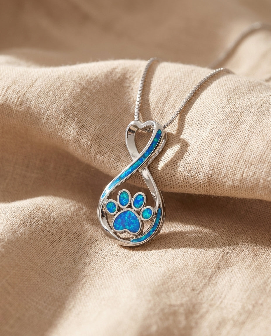 Estelle & Ruby Paw Print Heart Pendant Necklace, Titanium Steel, Blue Enamel Infinity Design (AI-generated studio image)