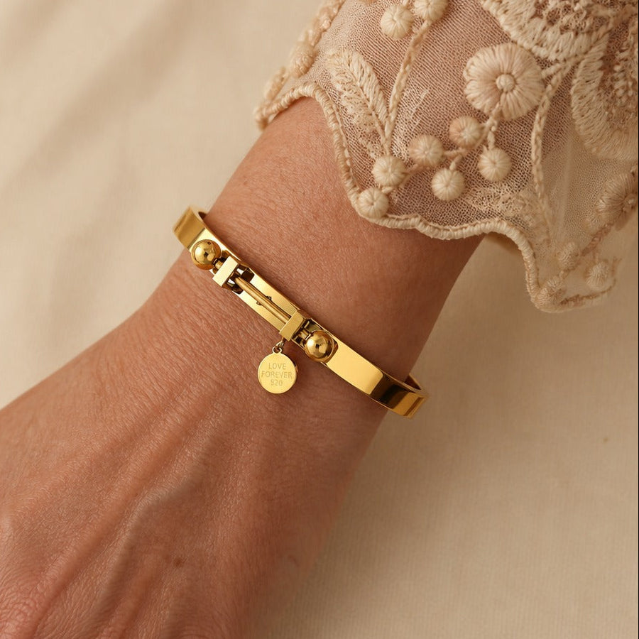 Hinged Gold Tone Bangle Bracelet with 'Love Forever' Disc Charm and Ball Bead Accents — main image