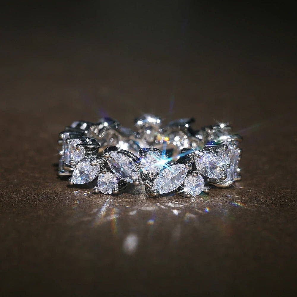 Marquise Stone Eternity Ring with Blue Accent Stone in Silver Tone — main image