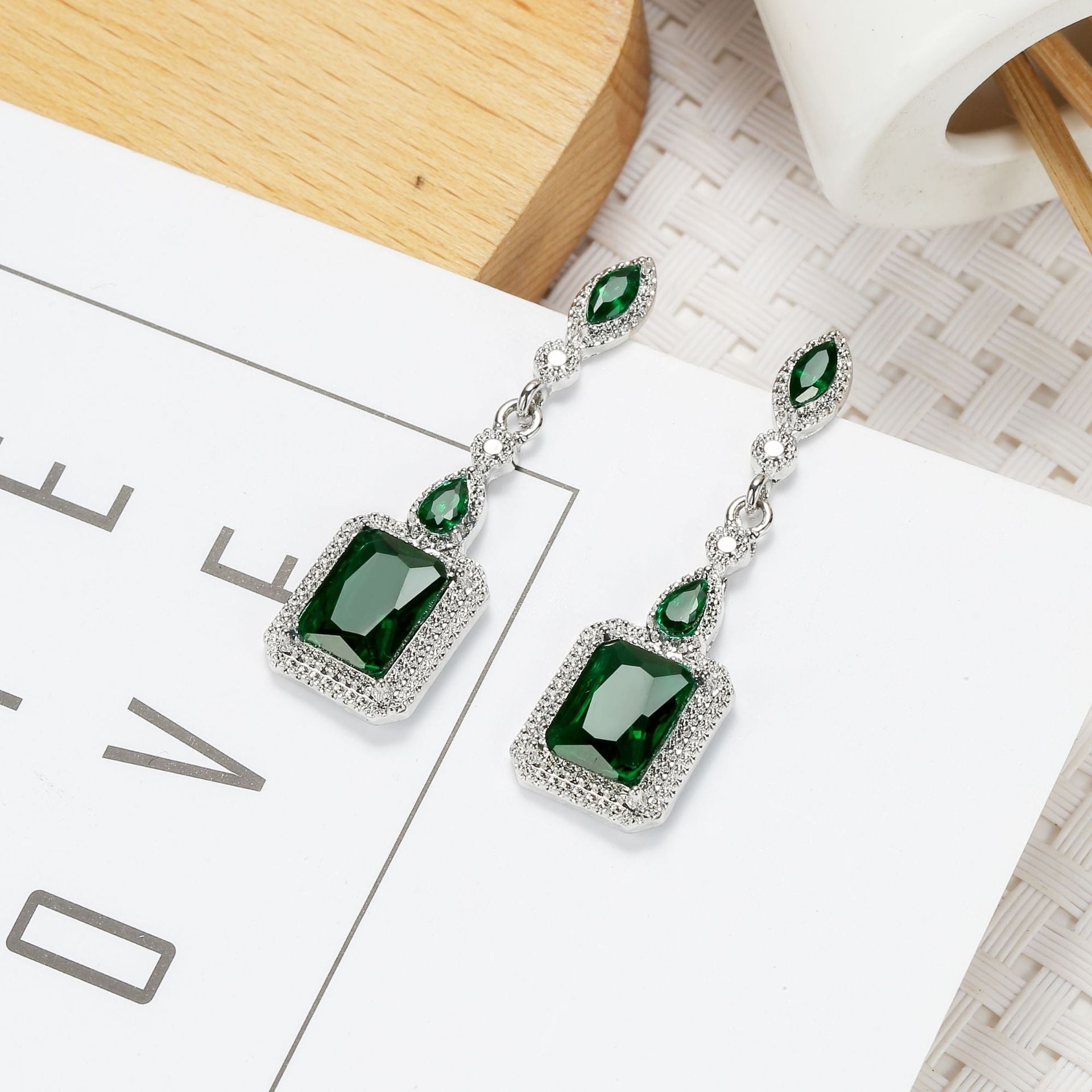 Emerald-Cut Green Stone Dangle Earrings with Silver-Tone Halo Accents