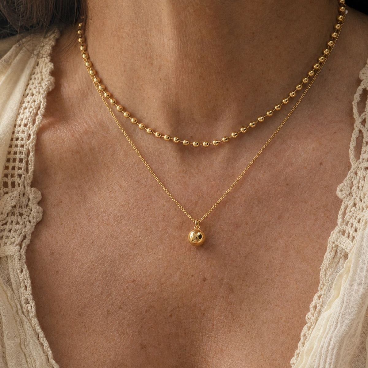 Layered Gold Necklace with Beaded Chain and Spherical Pendant — main image