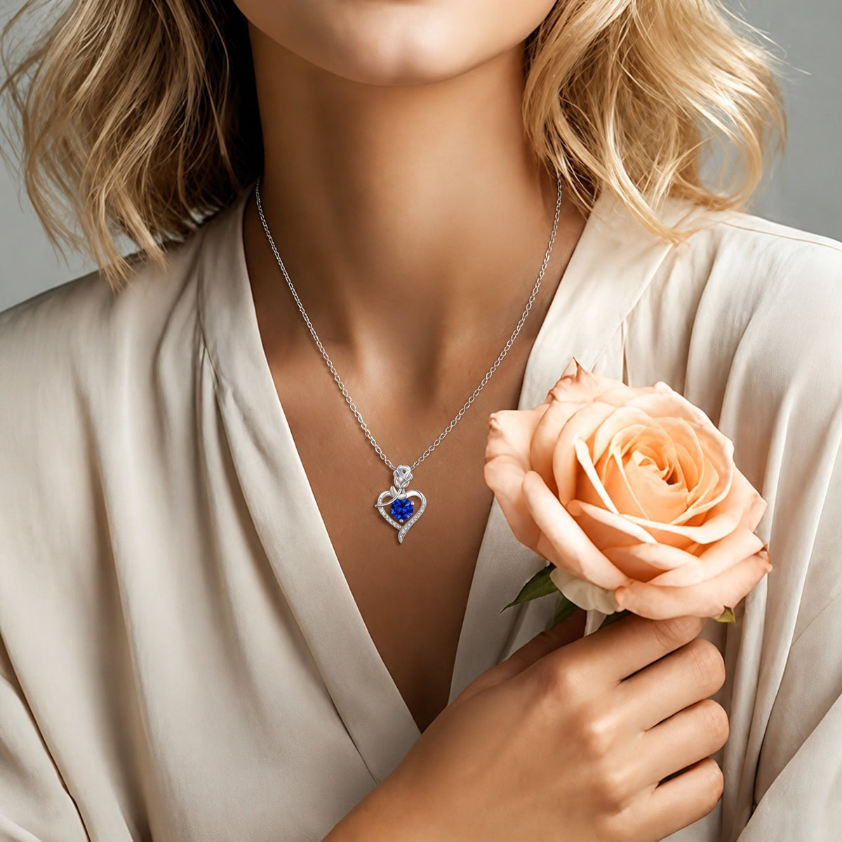 Heart-Shaped Sapphire Blue Pendant Necklace with Rose Detail and Silver-Tone Chain — view 2