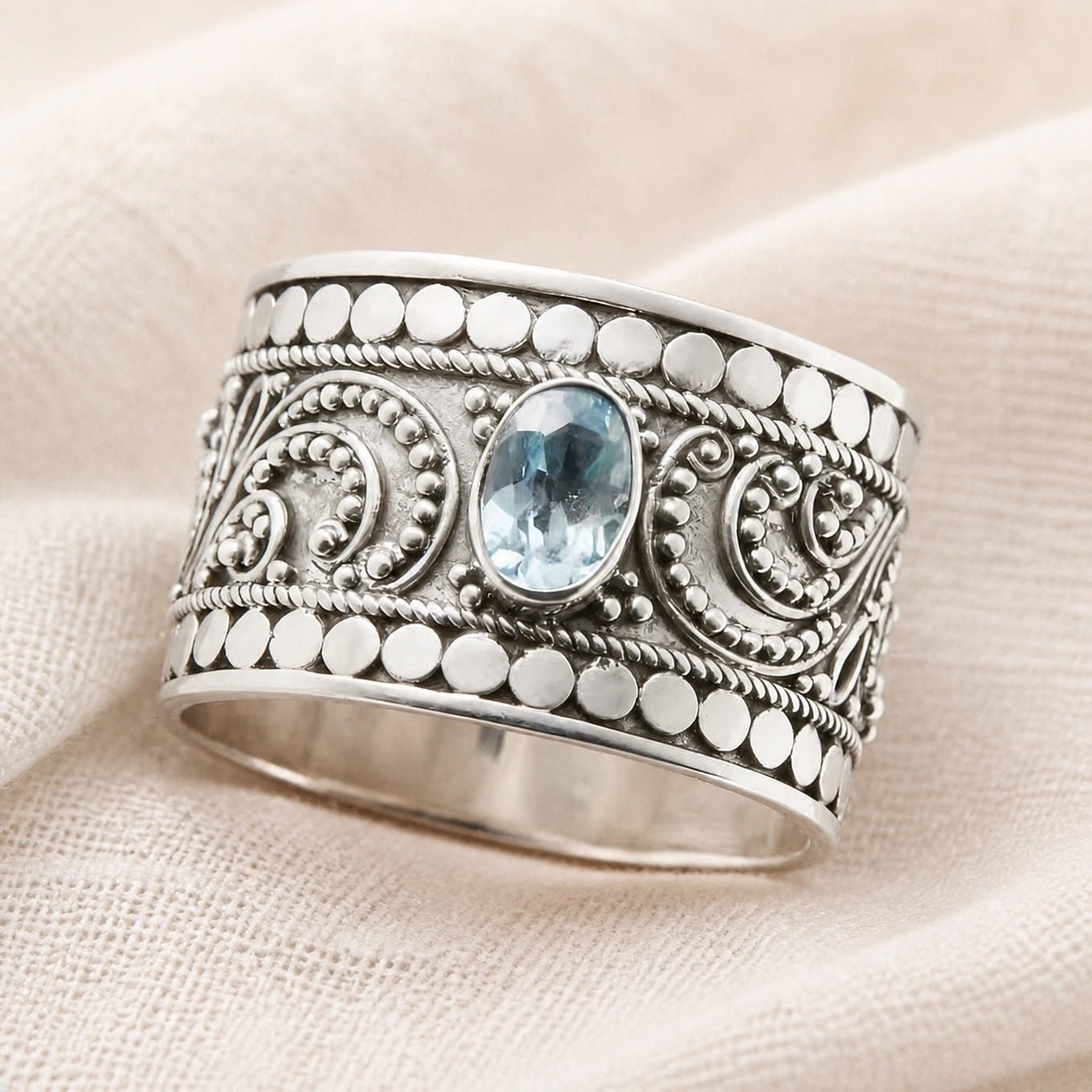 Oval Pale Blue Zirconia Ring with Wide Scroll Band Detail