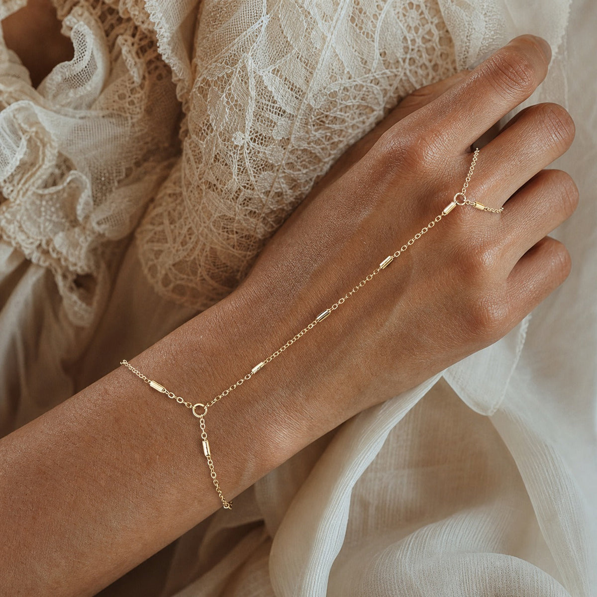 Beaded Hand Chain Bracelet with Gold-Tone Cylindrical Beads — main image
