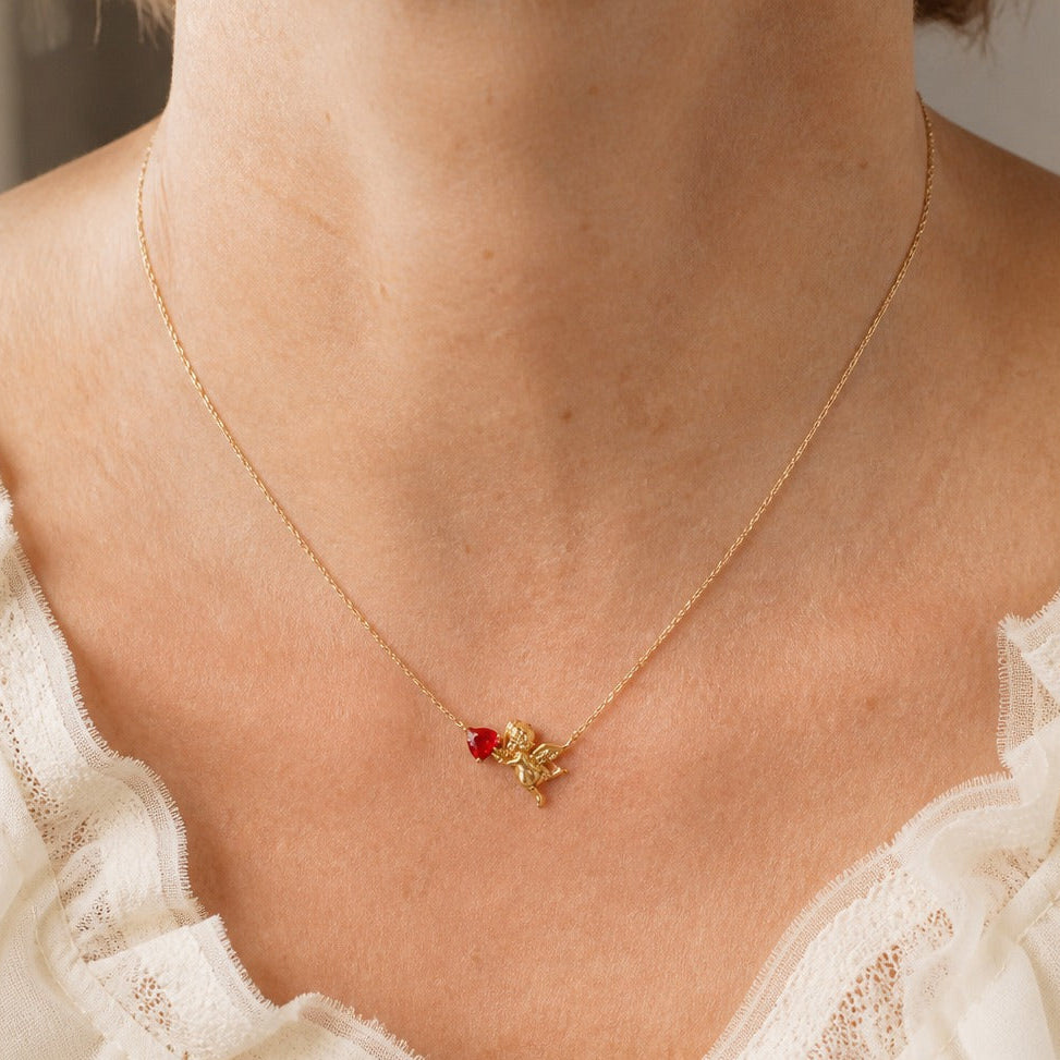 Cupid Motif Pendant Necklace with Red Faceted Stone on Gold-Tone Chain — main image