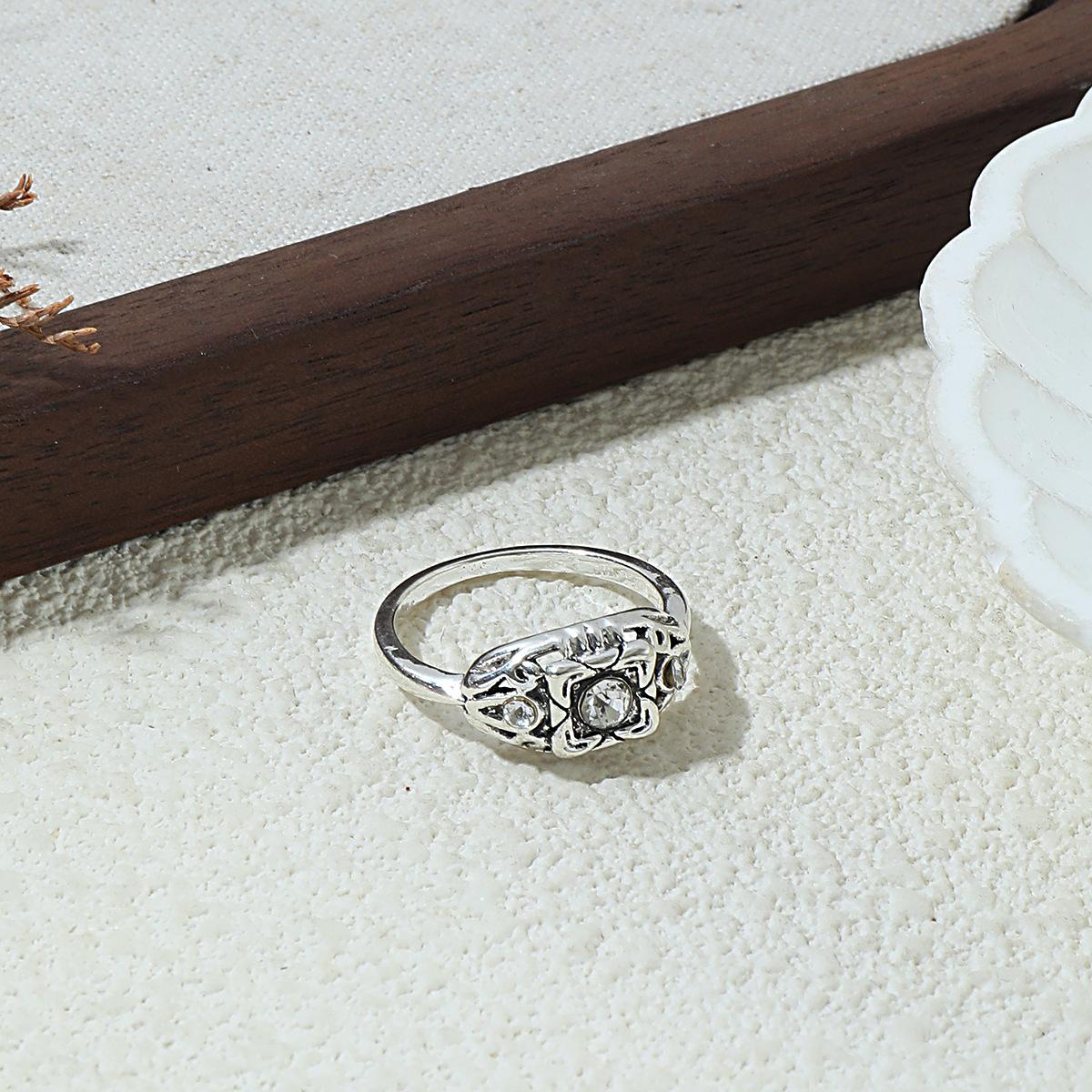 Vintage Art Deco Three-Stone Cubic Zirconia Ring with Silver-Tone Scrollwork
