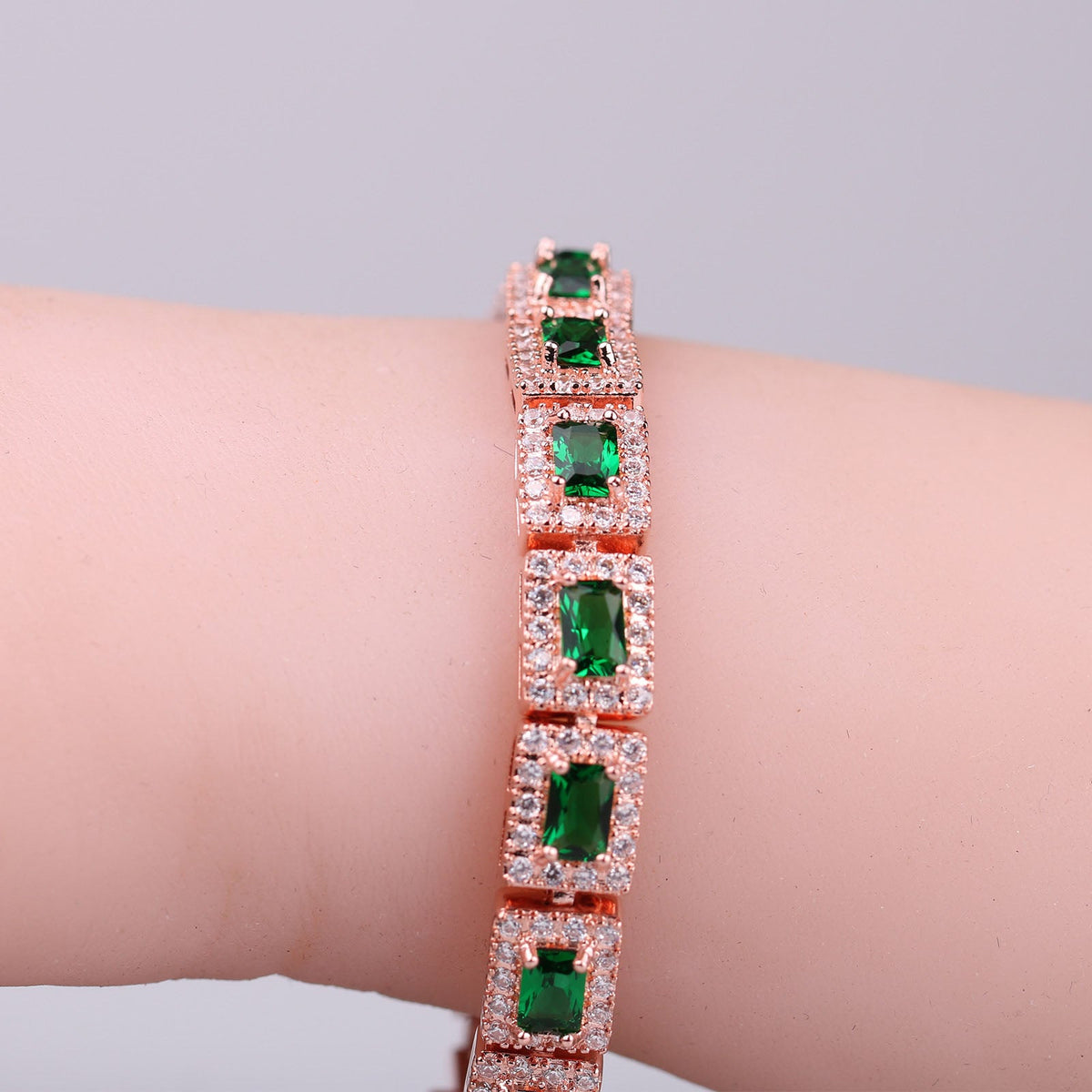 Emerald-Cut Green Stone Tennis Bracelet with Rose Gold Tone and Halo Accents — view 4