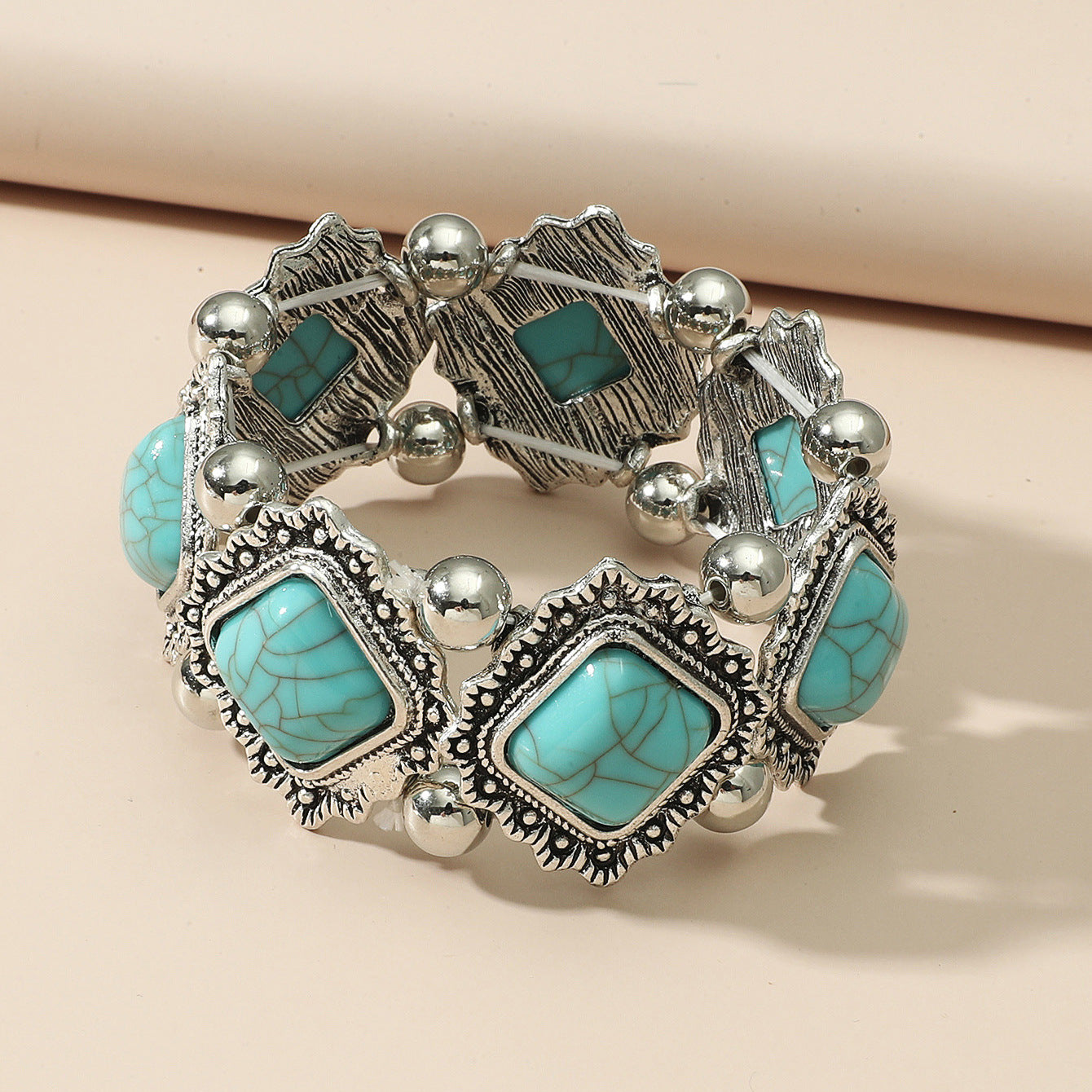 Turquoise Cushion-Cut Bracelet with Winged Filigree Charms