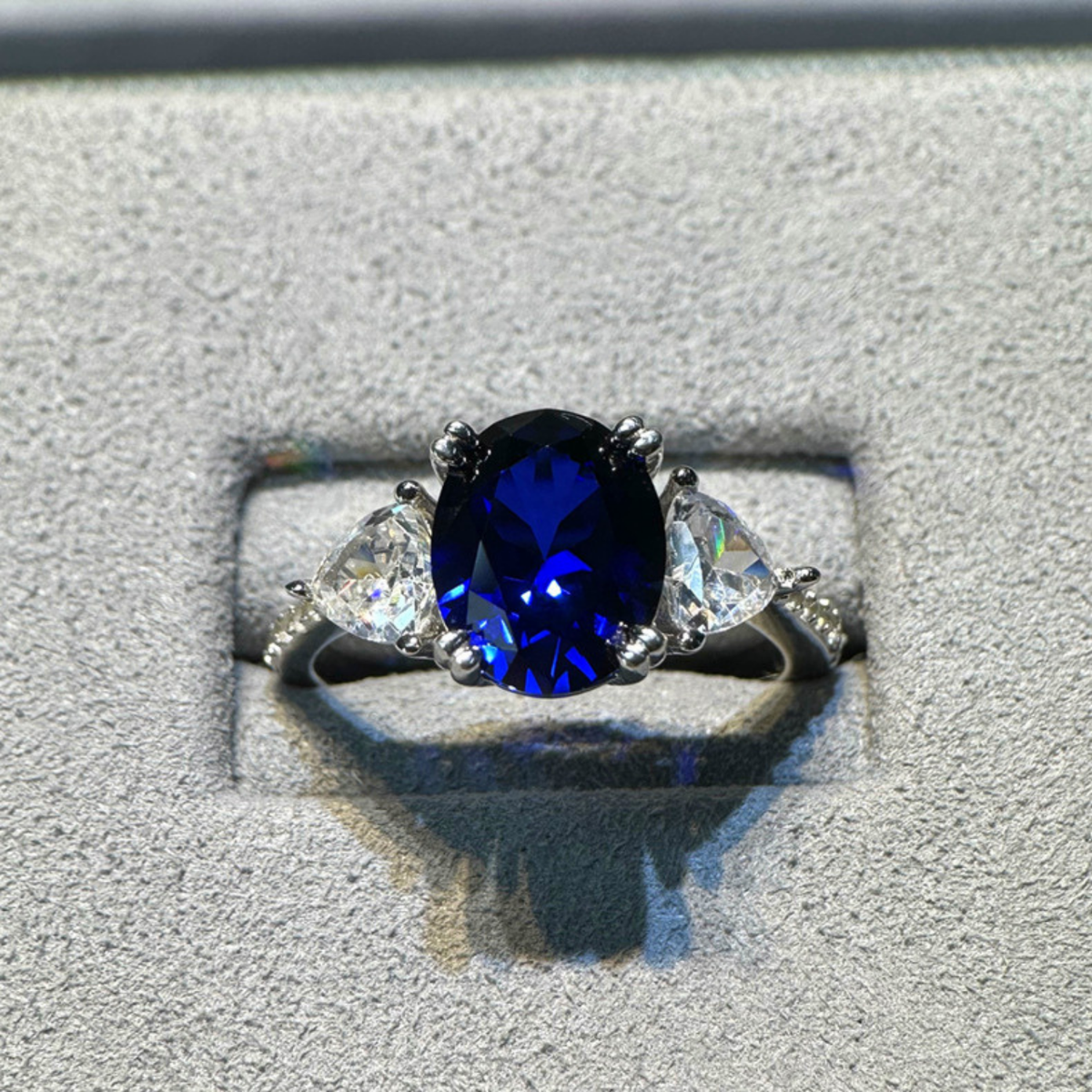 Oval Blue Sapphire Three-Stone Ring with Accent Stones — view 4