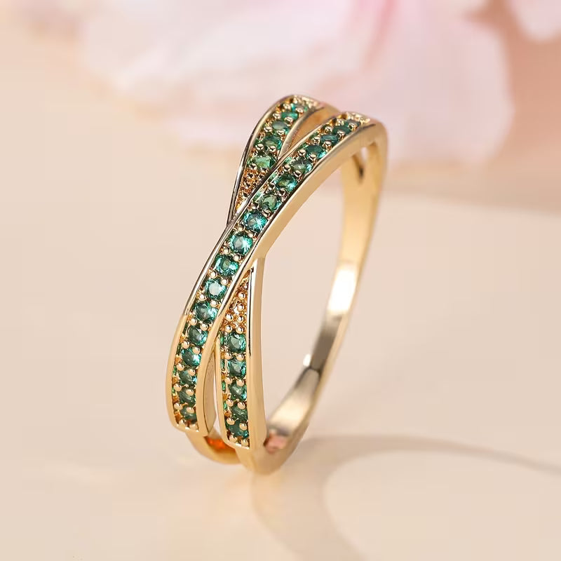 Twisted Emerald Crossover Ring with Pavé Detail and Two-Tone Gold Band