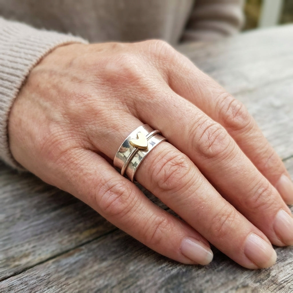 classic silver ring with golden heart accent — lifestyle