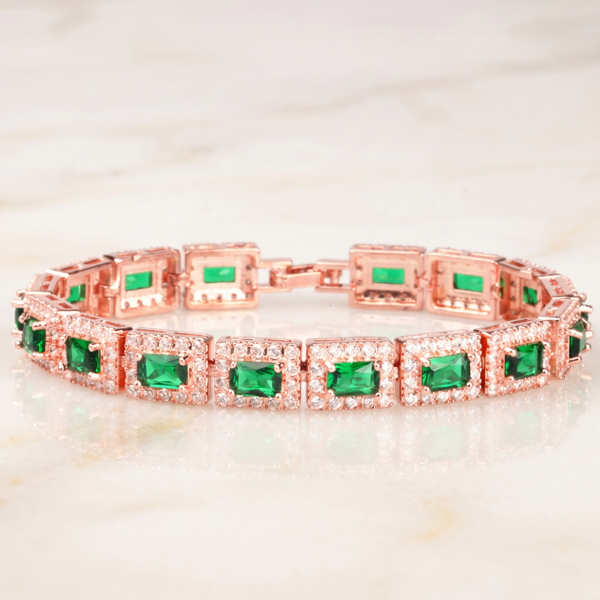 Emerald-Cut Green Stone Tennis Bracelet with Rose Gold Tone and Halo Accents — main image