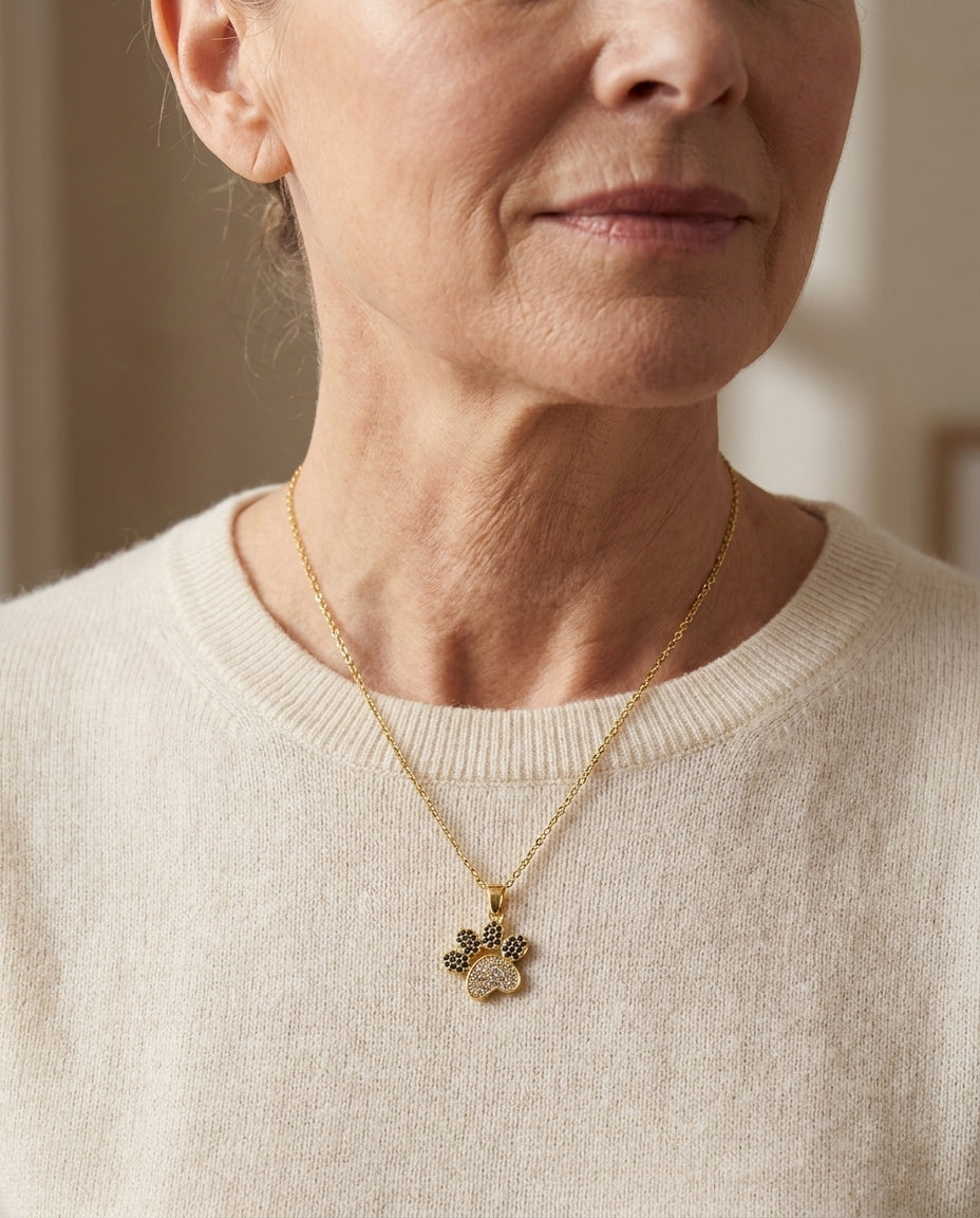 Estelle & Ruby Paw Print Pendant Necklace, Gold-Tone Stainless Steel with Rhinestone Inlay (AI-generated lifestyle image)