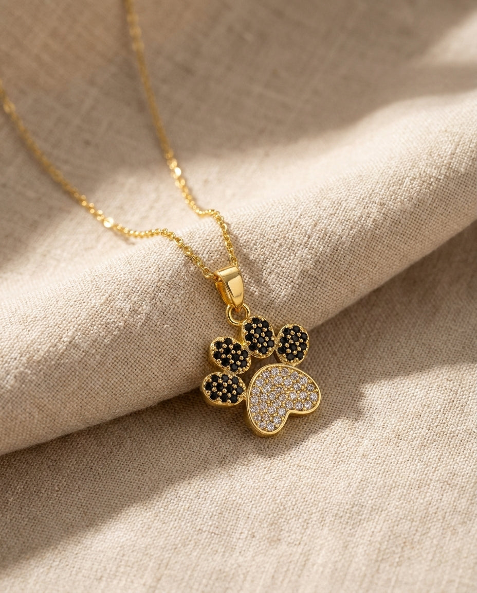 Estelle & Ruby Paw Print Pendant Necklace, Gold-Tone Stainless Steel with Rhinestone Inlay (AI-generated studio image)