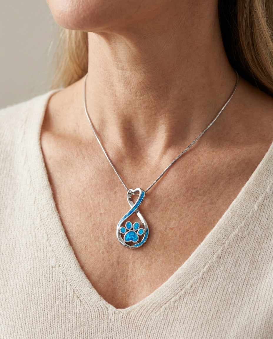 Estelle & Ruby Paw Print Heart Pendant Necklace, Titanium Steel, Blue Enamel Infinity Design (AI-generated lifestyle image)